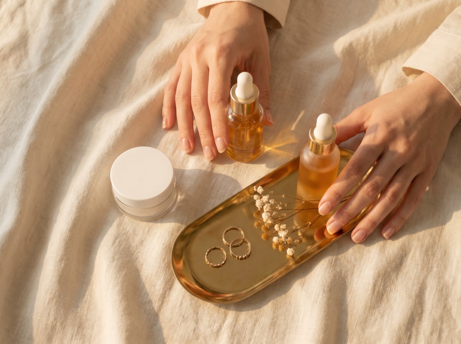 Hands styling a flat-lay of skincare products for a content shoot